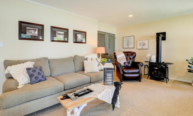 living area featuring crown molding, a wood stove, baseboards, and carpet floors