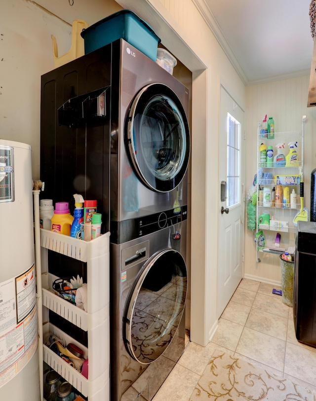 laundry room with laundry area, tile patterned flooring, crown molding, stacked washer / drying machine, and gas water heater