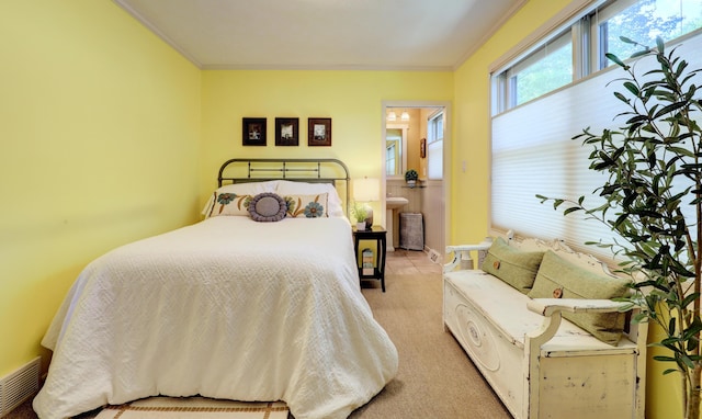 bedroom with visible vents, light carpet, and crown molding