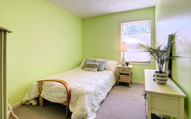 carpeted bedroom featuring baseboards