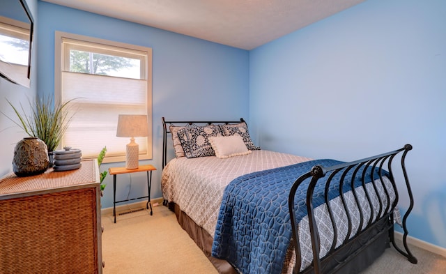 carpeted bedroom with baseboards