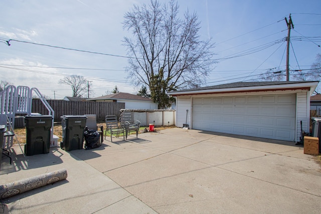 detached garage featuring fence