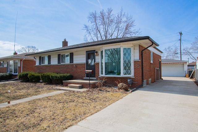 view of front of home featuring brick siding, a garage, a chimney, and an outdoor structure