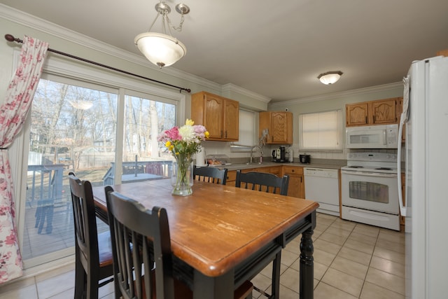 dining space featuring light tile patterned floors and crown molding