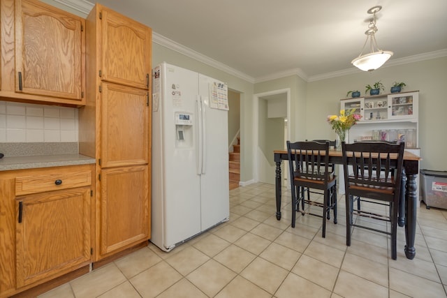 kitchen with tasteful backsplash, crown molding, light countertops, light tile patterned floors, and white refrigerator with ice dispenser