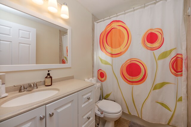 full bath featuring a shower with curtain, toilet, vanity, and tile patterned flooring