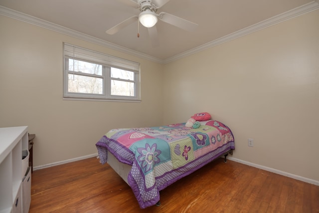 bedroom with baseboards, wood finished floors, and crown molding