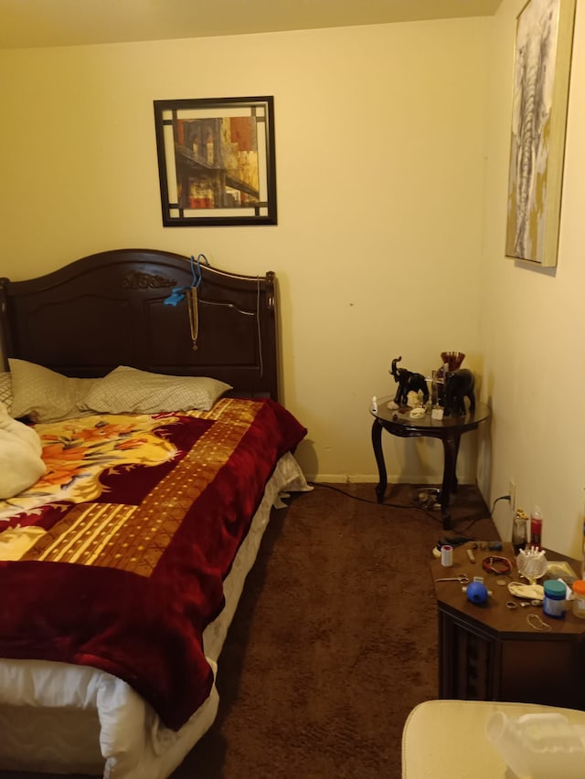 bedroom featuring baseboards and carpet