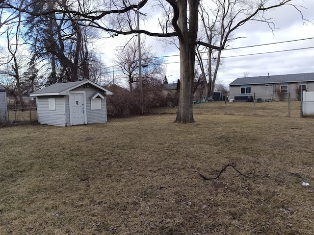 view of yard with a storage unit, an outdoor structure, and fence