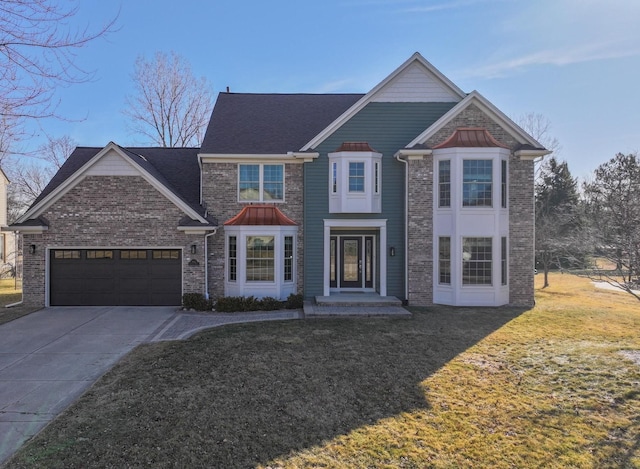 traditional-style home featuring a front yard, an attached garage, brick siding, and driveway