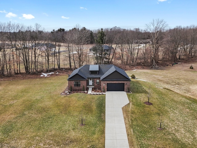 view of front of home with concrete driveway, a front yard, a shingled roof, a garage, and brick siding