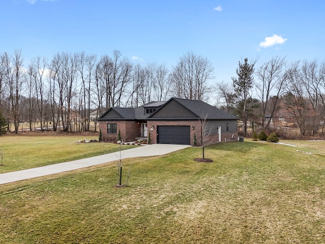 view of front of home with a front lawn, brick siding, concrete driveway, and an attached garage