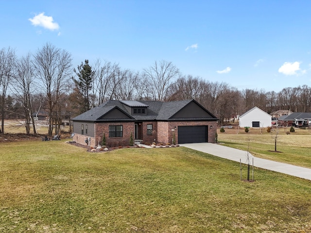 view of front of house with concrete driveway, an attached garage, brick siding, and a front yard