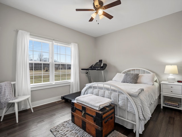 bedroom with wood finished floors, baseboards, and ceiling fan