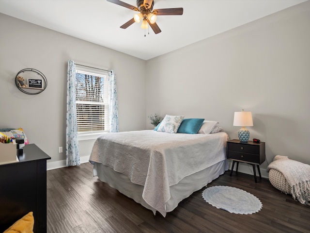 bedroom with ceiling fan, baseboards, and wood finished floors