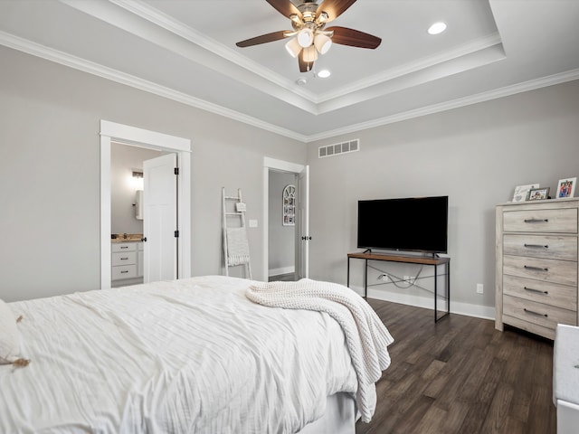 bedroom with visible vents, ornamental molding, a tray ceiling, baseboards, and dark wood-style flooring