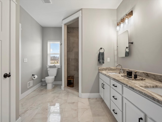 full bathroom with vanity, baseboards, tiled shower, toilet, and marble finish floor