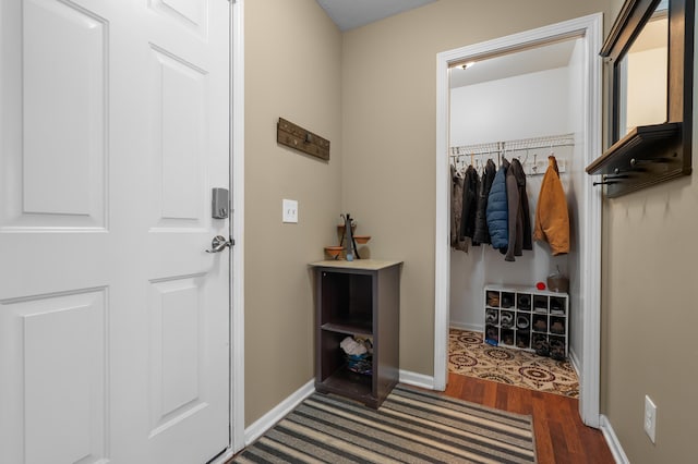 interior space featuring baseboards and wood finished floors