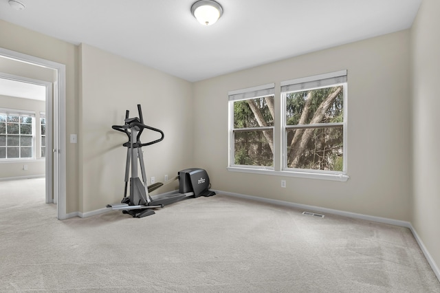 workout room with visible vents, baseboards, and carpet floors