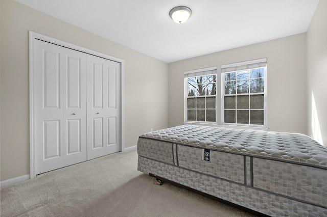 bedroom featuring carpet, a closet, and baseboards