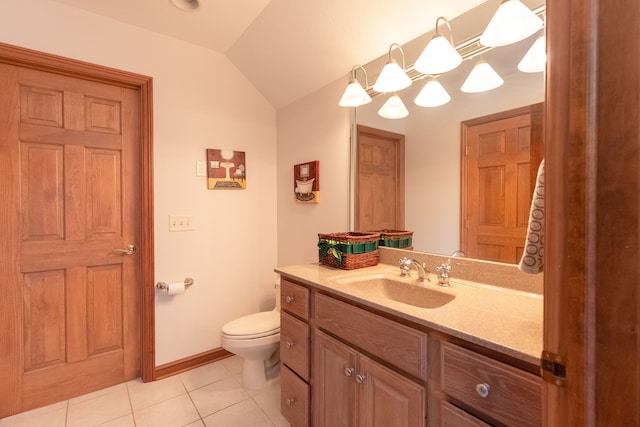 bathroom featuring baseboards, toilet, vaulted ceiling, tile patterned floors, and vanity