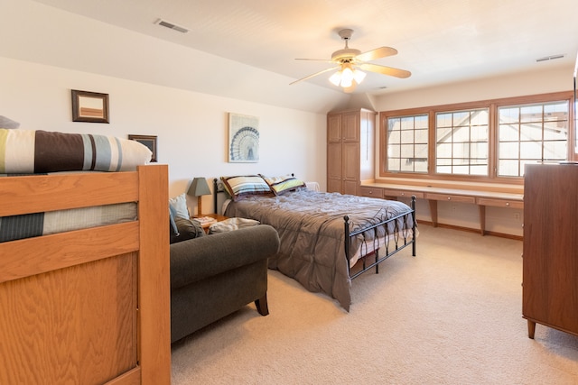 bedroom featuring visible vents, light colored carpet, a ceiling fan, and vaulted ceiling