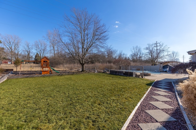 view of yard featuring a playground, a fenced backyard, and a fenced in pool