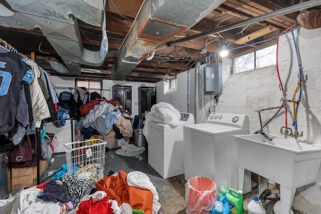 below grade area with washer and dryer, electric panel, and a sink