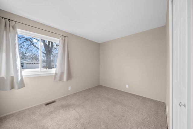 carpeted spare room with visible vents