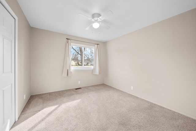 unfurnished bedroom featuring visible vents, carpet floors, and ceiling fan