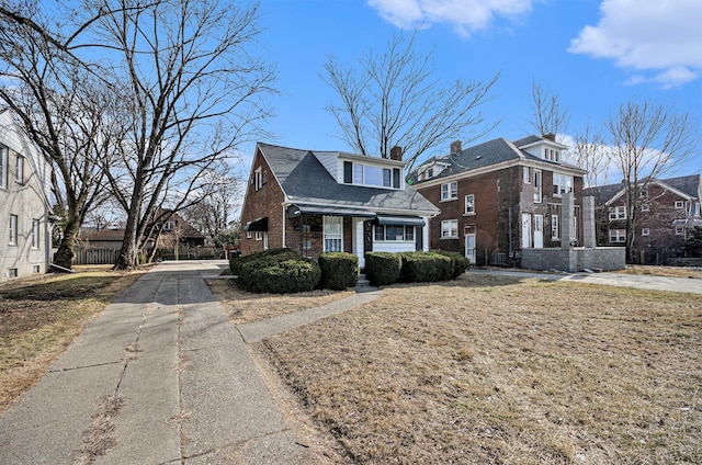 view of front of home featuring brick siding and a residential view