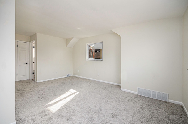 unfurnished room with visible vents, baseboards, and carpet