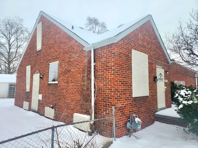 20048 Fleming St, Detroit, MI 48234 - view of snowy exterior with fence and brick siding