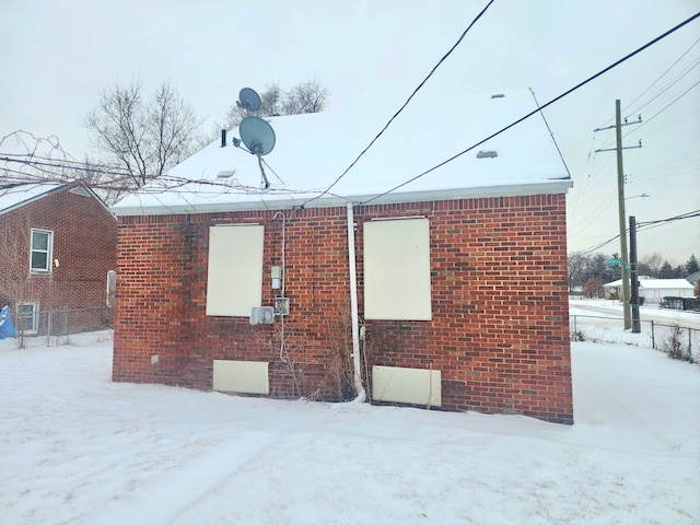 20048 Fleming St, Detroit, MI 48234 - snow covered property featuring brick siding, crawl space, and fence