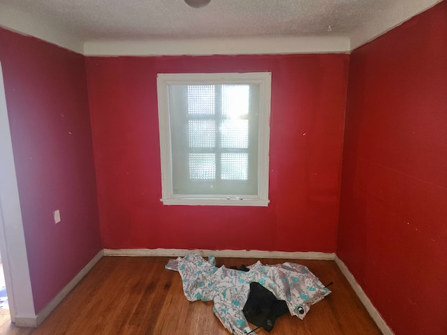 20048 Fleming St, Detroit, MI 48234 - unfurnished room with baseboards, wood finished floors, and a textured ceiling