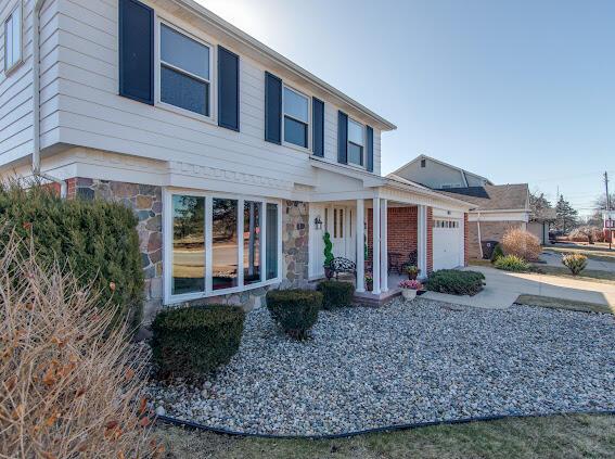 view of front of house featuring stone siding and a garage