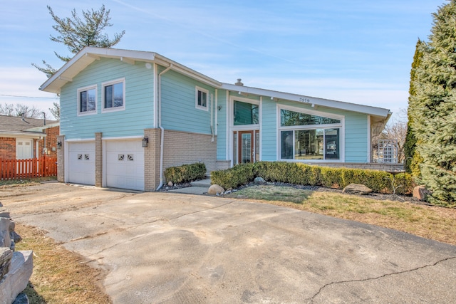 view of front of house featuring concrete driveway, brick siding, and a garage