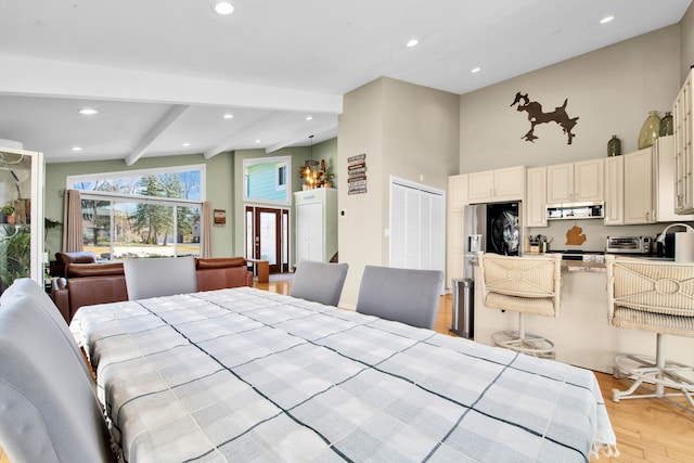 bedroom featuring beam ceiling, recessed lighting, a sink, light wood-style floors, and fridge with ice dispenser