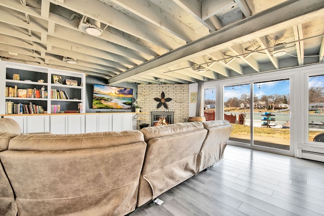 living room featuring wood finished floors, a fireplace, a baseboard radiator, and beam ceiling