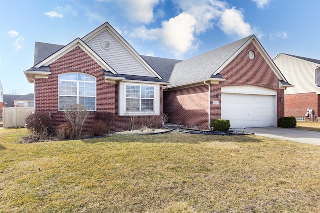 view of front facade featuring driveway, roof with shingles, a front yard, a garage, and brick siding