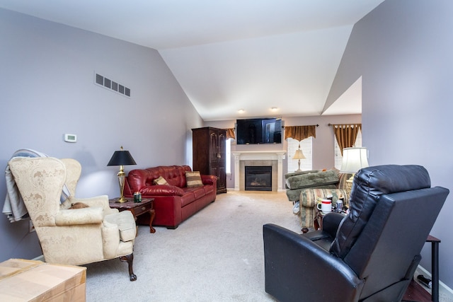 living area featuring visible vents, light colored carpet, high vaulted ceiling, and a tile fireplace