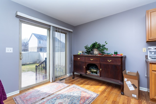 living area with light wood finished floors and baseboards