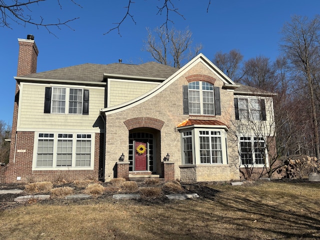 traditional home with brick siding and a chimney