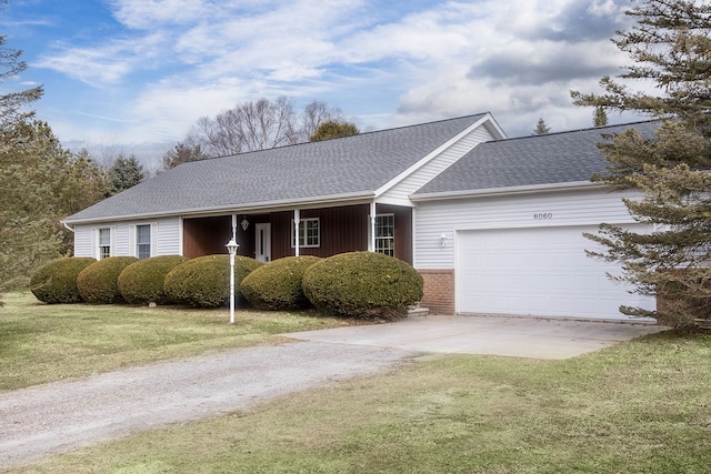 single story home with a front yard, roof with shingles, concrete driveway, a garage, and brick siding