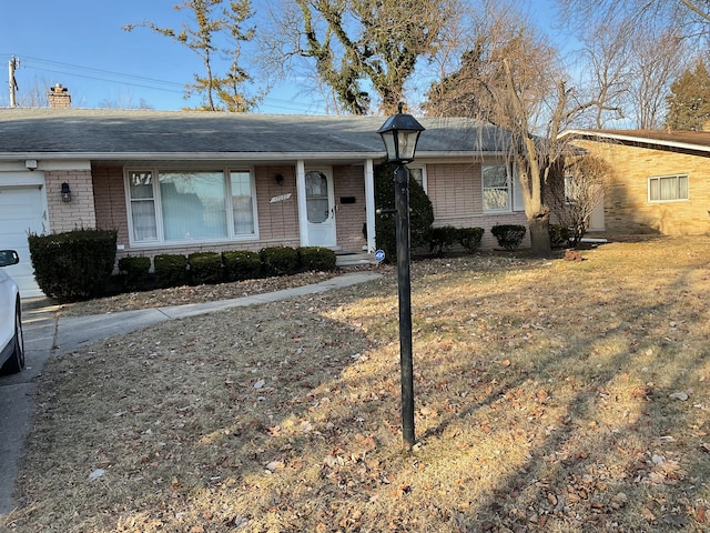 ranch-style house with an attached garage, brick siding, and a shingled roof