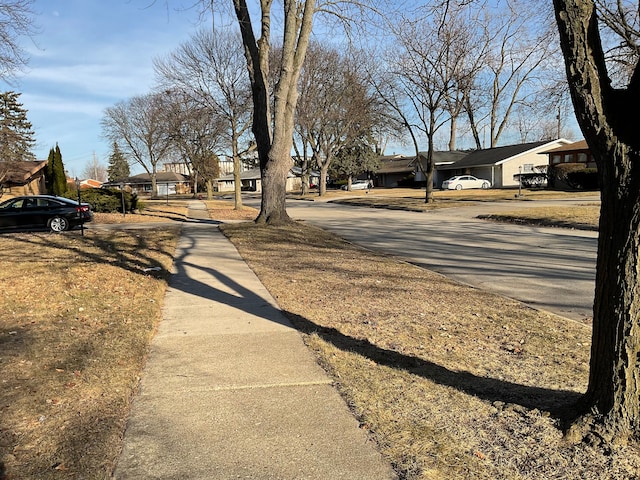 view of road with a residential view and sidewalks