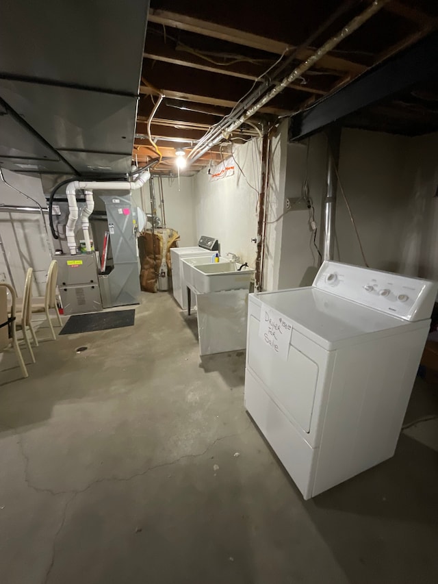 unfinished below grade area with washer and dryer and heating unit