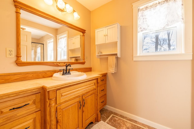 bathroom featuring baseboards and vanity