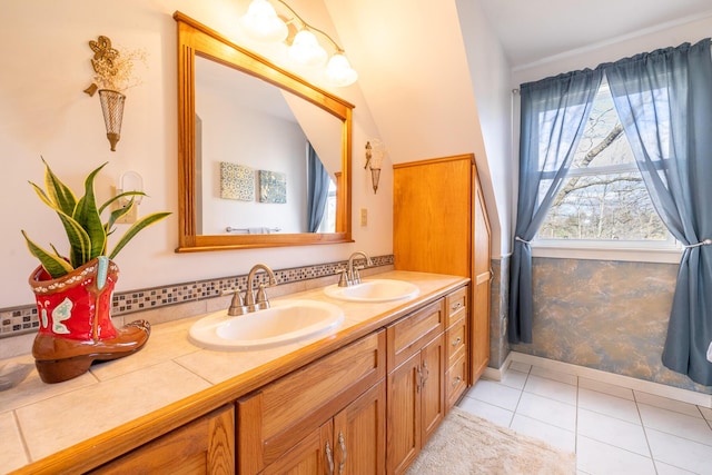 bathroom featuring a sink, decorative backsplash, double vanity, and tile patterned floors