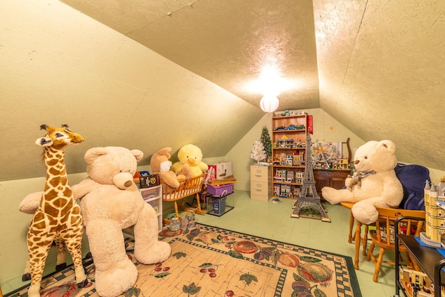 playroom with a textured ceiling and vaulted ceiling